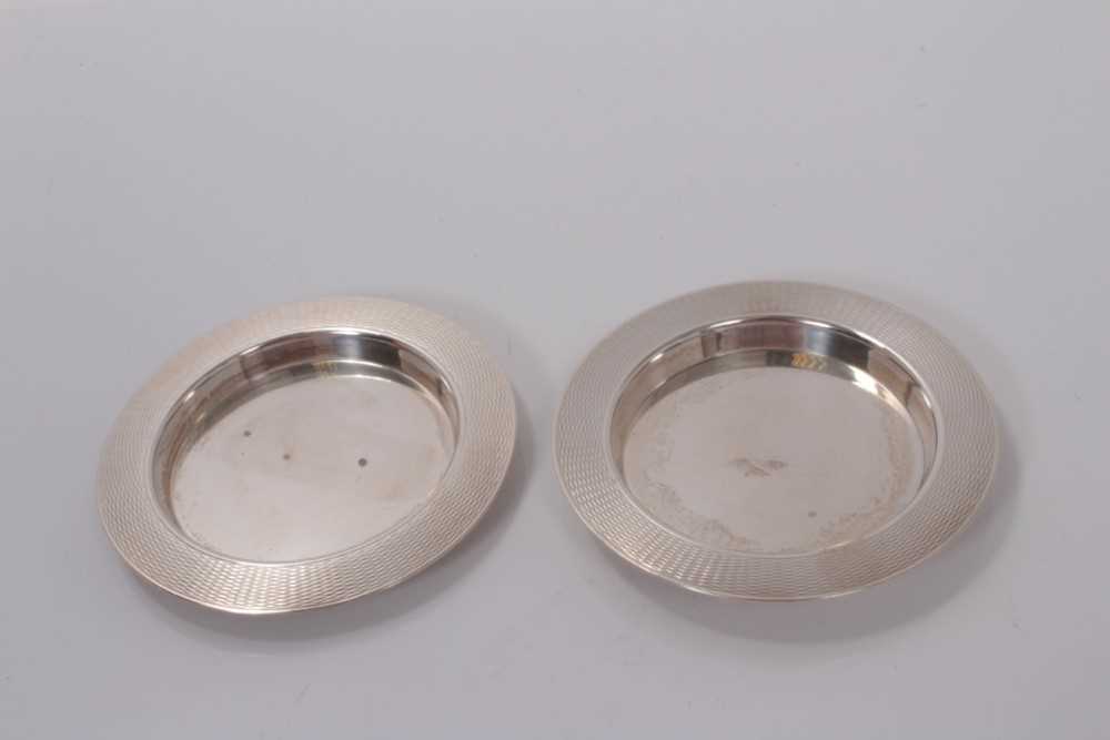 Lot 51 - Pair of George VI silver pin dishes of circular form with engine turned decoration to borders, (London 1946) maker, Mappin & Webb Ltd, 9.5cm in diameter, all at 3ozs (2)