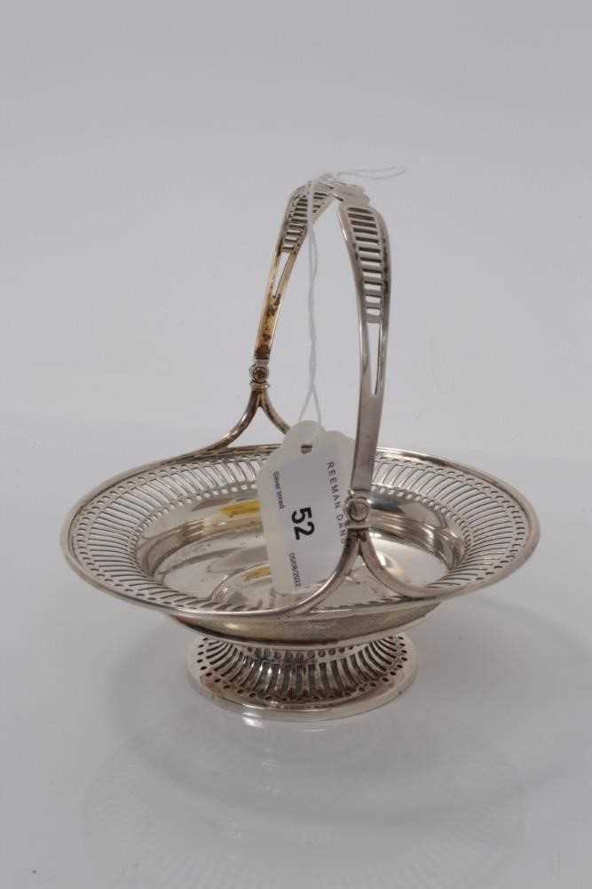 Lot 52 - Edwardian silver bonbon dish of circular form with pierced decoration and central swing handle, raised on pedestal foot, (London 1905), maker Mappin & Webb Ltd, 12.5cm in diameter, all at 4ozs.