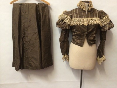 Lot 2090 - Victorian striped brown silk taffeta cropped fitted jacket and shoulder puff sleeves and lace trim with matcting skirt. A Victorian black silk half hat with black feathers and a straw half hat wit...