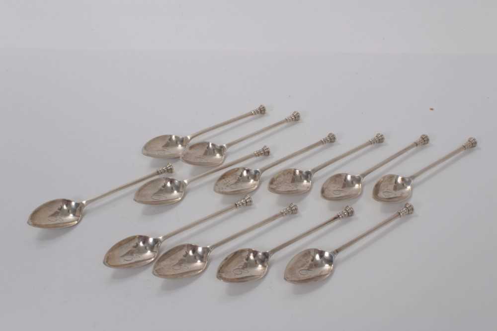 Lot 56 - Set of twelve George V silver seal top tea spoons, each bowl engraved with a letter C, (Sheffield 1910), maker C W Fletcher & Son Ltd, all at 4ozs (12)