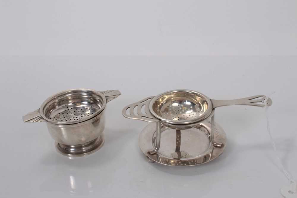Lot 59 - George V silver tea strainer and bowl, (Birmingham 1919), together with another silver tea strainer with an associated stand (Birmingham 1914 / 1931), all at 5ozs. (4)