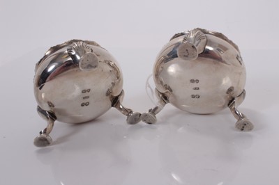 Lot 61 - Pair of Victorian silver salts of cauldron form with engraved armorials, gilded interiors and raised on three hoof feet, (London 1841), maker W. M., 6.5cm in diameter , all at 6ozs (2)