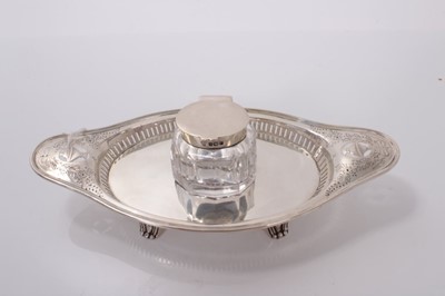 Lot 63 - Edwardian silver inkstand with pierced and engraved decoration and central cut glass inkwell with silver mount, (Sheffield 1908), maker Hawksworth, Eyre & Co Ltd, stand 22cm in length, 4ozs of weig...