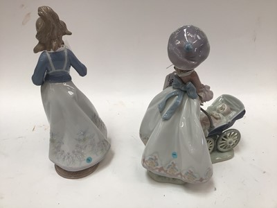 Lot 1061 - Two Lladro porcelain figures - Lady holding baby and Lady with pushchair and baby