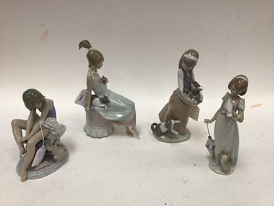 Lot 1062 - Four Lladro porcelain figures - Girls with cats