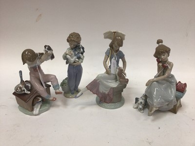 Lot 1064 - Four Lladro porcelain figures including Pick of the litter and Picture Perfect (both boxed)