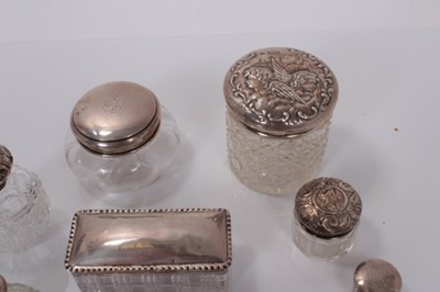 Lot 139 - Group of seven Victorian and later silver topped cut glass vanity jars together with a cut glass scent bottle with silver plated top (various dates and makers) (8).