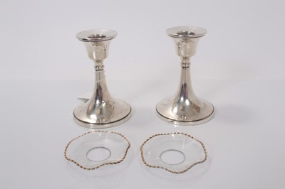 Lot 143 - Pair of George V silver dwarf candlesticks with flared central columns on circular bases, (Birmingham 1923), maker William Devenport, 11cm in overall height. (2)