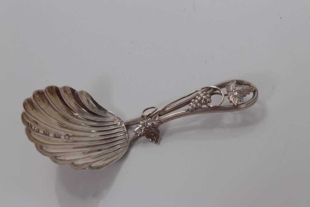 Lot 101 - Victorian silver shell bowl caddy spoon with vine decorated handle, Birmingham 1852, George Unite 8cm