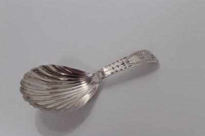 Lot 109 - George III silver shell bowl caddy spoon with bright cut decoration, London 1777, Elizabeth Morley, 9cm