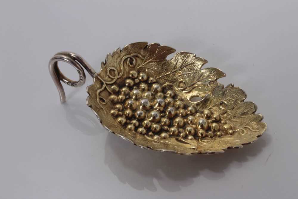 Lot 114 - George III silver gilt leaf and grape embossed caddy spoon with loop handle, Birmingham 1808, maker rubbed 6.5cm