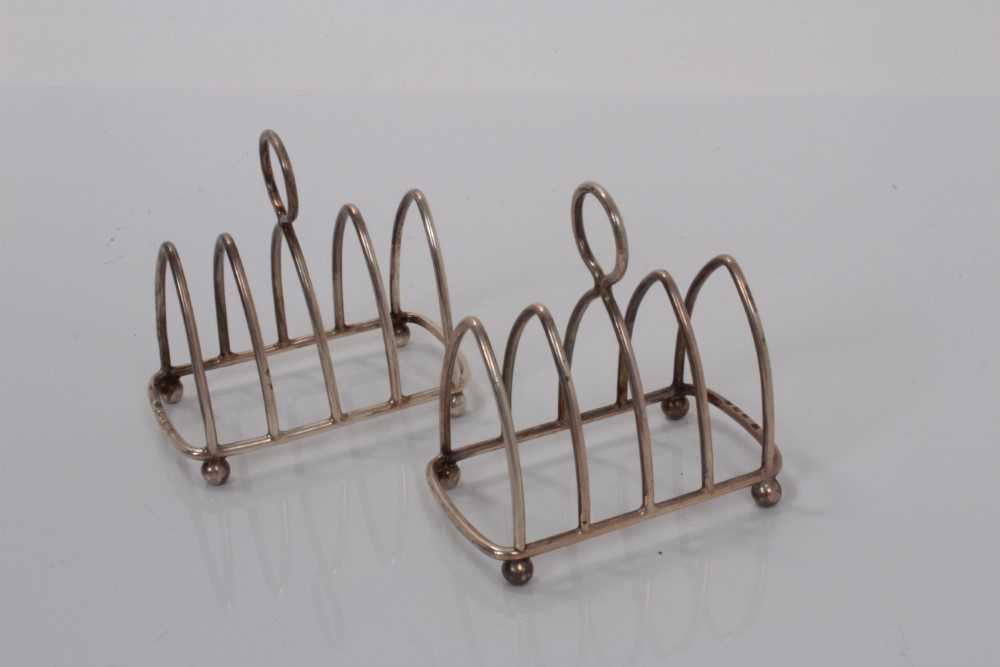 Lot 168 - Pair of George V silver four division toast racks (Birmingham 1923 / Chester 1924), maker Haseler & Bill, all at 2ozs (2)