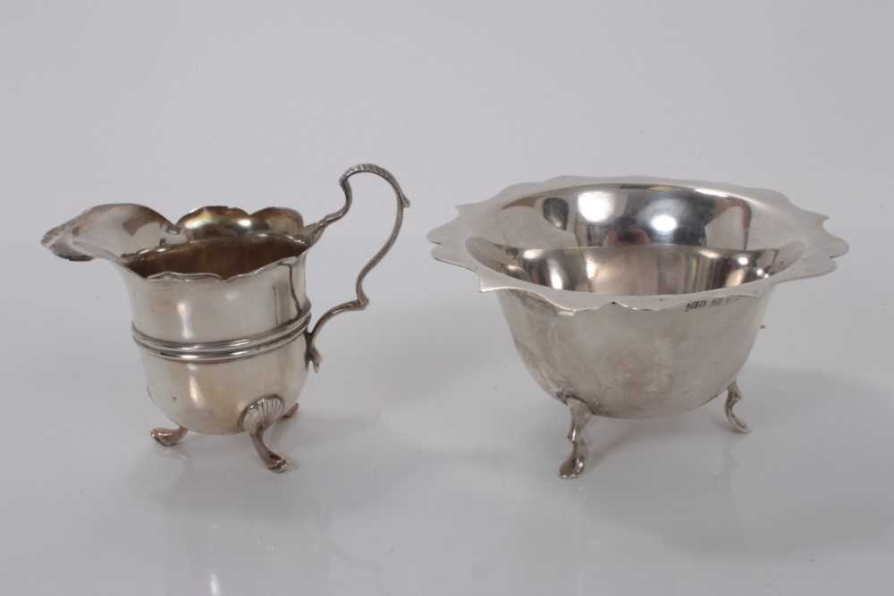 Lot 170 - Edwardian silver sugar bowl, raised on three hoof feet, (Birmingham 1902), together with a similar Edwardian silver cream jug (Sheffield 1901), all at 5ozs, (2)