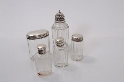 Lot 172 - George III silver topped cut glass caster, (Sheffield 1820), together with silver topped cut glass vanity jars (various dates and makers) (5)