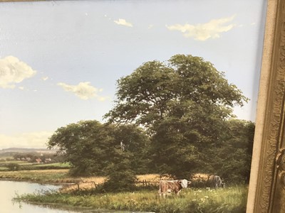 Lot 128 - David Morgan (Born 1947) - oil on canvas in gilt frame - Cows grazing in meadow by river