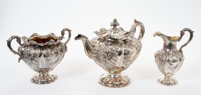 Lot 200 - Early Victorian Scottish silver three piece tea set of melon form with repoussé floral decoration
