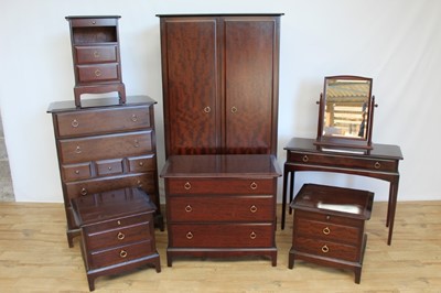 Lot 15 - Stag mahogany bedroom suite comprising double wardrobe, chest of four short and three long drawers, pair of bedside chests, dressing table and dressing mirror, chest of three drawers and another be...