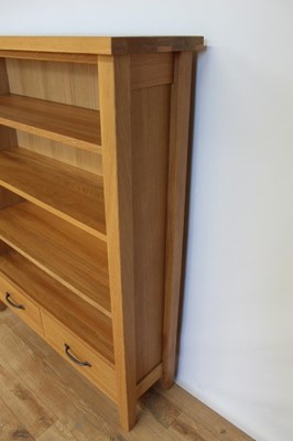 Lot 17 - Contemporary light oak open bookcase with adjustable shelves and two drawers below, 95cm wide, 28.5cm deep, 120cm high