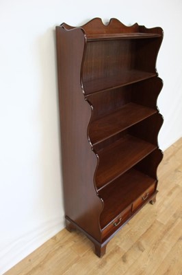 Lot 19 - Mahogany waterfall bookcase with two drawers below, 76cm wide, 38.5cm deep, 152cm high