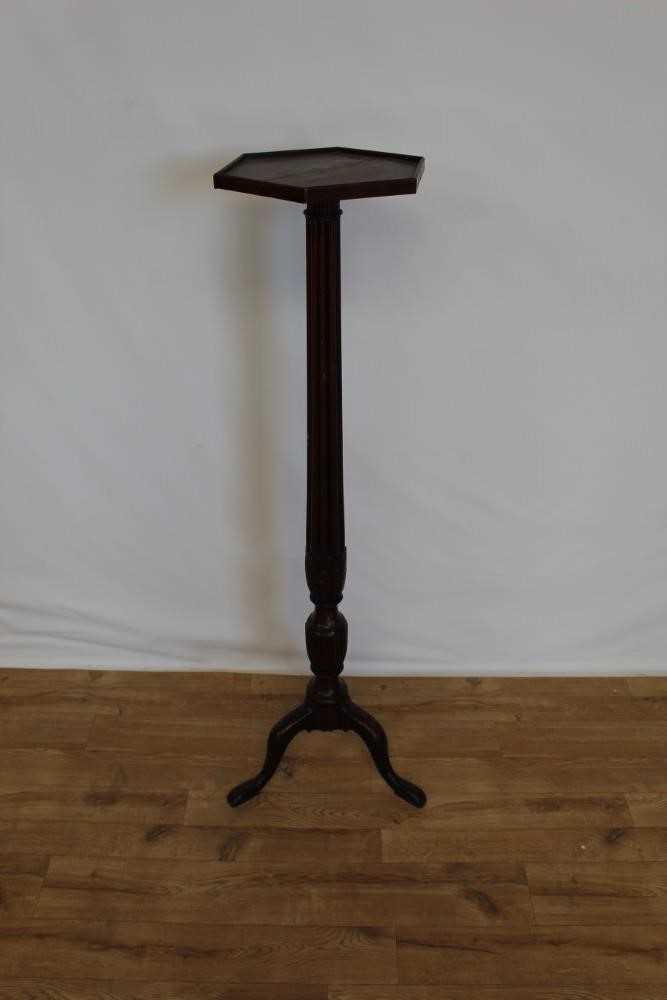 Lot 20 - Late Victorian mahogany torchere with hexagonal top on reeded column and three hipped splayed legs, 134cm high