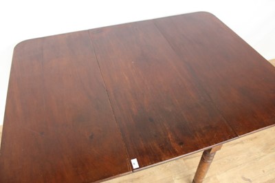 Lot 46 - Nineteenth century mahogany drop leaf table on turned legs, opening to 145cm x 107cm