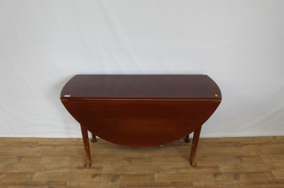Lot 50 - Mahogany oval drop leaf table on turned legs, opening to 128cm x 122cm