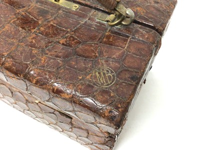 Lot 80 - Asprey crocodile leather vanity case containing Asprey silver mounted dressing table items