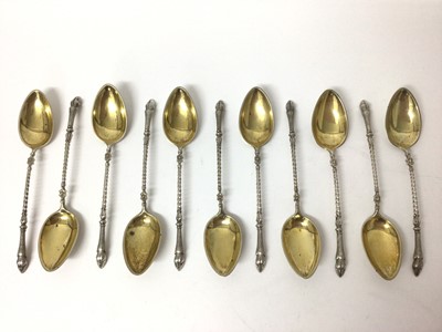 Lot 115 - Eleven silver (800) teaspoons with hoof terminals and gilt bowls