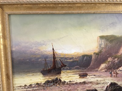 Lot 5 - Frank Hider (1861 - 1933) oil on canvas-  A seascape with fisherfolk and a moored vessel near cliffs, signed, 49cm x 29cm framed