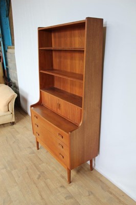 Lot 71 - Mid 20th century teak bookcase with adjustable shelves above, stationary compartment enclosed by tambour shutter and three drawers below, 100.5cm wide, 42.5cm deep, 182cm high