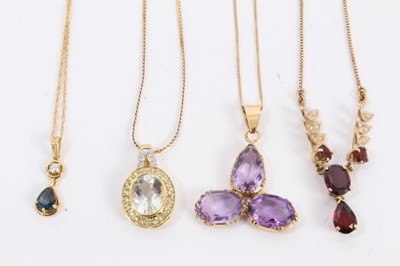 Lot 469 - Four gold and gem-set pendants to include aquamarine, diamond and peridot pendant in 18ct gold, blue spinel and diamond pendant in 18ct gold, amethyst pendant in gold setting and a garnet and seed...