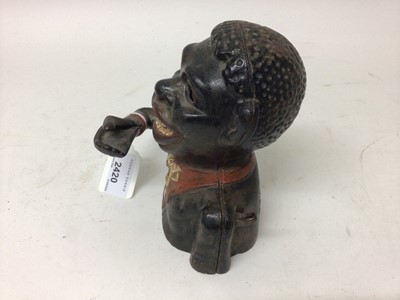 Lot 2420 - Early 20th century cast iron mechanical novelty money box/bank in the form of a gentleman in a black jacket with red collar, moveable arm, tongue and eyes. Base plate plug missing. 15cm overall hei...