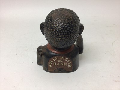 Lot 2420 - Early 20th century cast iron mechanical novelty money box/bank in the form of a gentleman in a black jacket with red collar, moveable arm, tongue and eyes. Base plate plug missing. 15cm overall hei...
