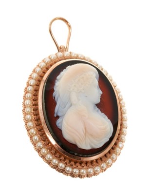 Lot 470 - 19th century carved hardstone cameo pendant brooch in rose gold mount with a border of seed pearls
