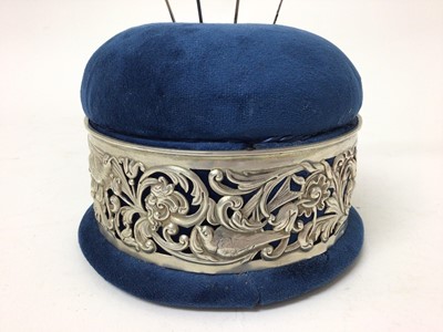 Lot 193 - Sterling silver mounted pin cushion, the pierced decoration with birds, flowers and scrollwork patterns, hallmarked for William Comyns, London 1895, together with four hat pins