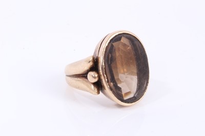 Lot 525 - Antique 9ct gold and smokey quartz signet ring with a large oval mixed cut smokey quartz in rub-over setting on heavy 9ct gold shank, stamped 9ct.