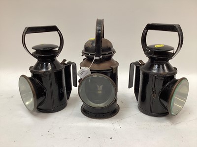 Lot 2428 - Three vintage black-painted railway lamps