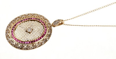 Lot 475 - Art Deco style ruby and diamond pendant with a central brilliant cut diamond on a gold lattice work ground with a border of calibre cut rubies and a pierced border of diamonds in 18ct gold setting...