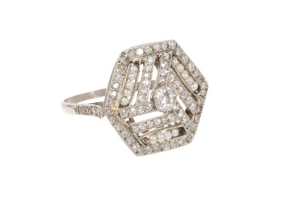 Lot 476 - Art Deco diamond and seed pearl ring with a hexagonal openwork plaque centred with an old cut diamond with geometric rows of rose cut diamonds and seed pearls, in platinum millegrain setting with f...