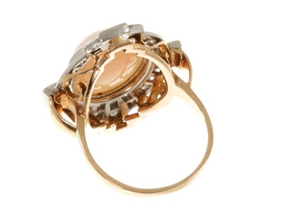 Lot 513 - Art Deco style opal and diamond cluster ring with an oval cabochon opal surrounded by a border of diamonds in platinum millegrain setting with pierced gold gallery on gold shank.