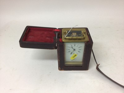 Lot 2439 - Good brass carriage clock, the enamel dial with Roman and Arabic numerals, secondary alarm dial, bevelled glass, 12cm high, in red leatherette case