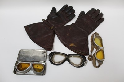 Lot 2021 - Pair of vintage brown leather driving gloves, the press studs marked 'Newey pat.' together with three pairs of vintage driving googles (4).