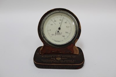 Lot 2024 - Vintage car dealership / promotional Rototherm desk barometer on leather stand marked 'Aldgate & City Motors Ltd, Ford main dealers, 39 Commercial Road, London E.1', 12cm in height.