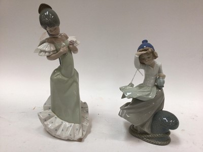 Lot 1099 - Four Nao porcelain figures including girl with three rabbits and girl holding a flower