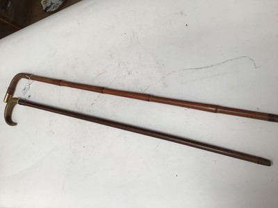 Lot 739 - Military interest- Gentleman's bamboo walking cane by Brigg with 9ct gold mount engraved 'C.E.P. Guards Club' together with a walking stick with horn grip and silver collar (2)