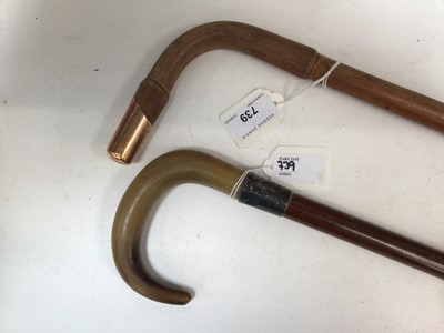 Lot 739 - Military interest- Gentleman's bamboo walking cane by Brigg with 9ct gold mount engraved 'C.E.P. Guards Club' together with a walking stick with horn grip and silver collar (2)