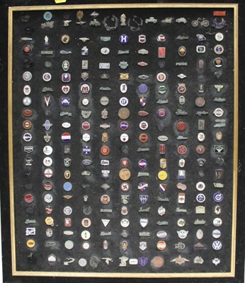 Lot 2035 - Display board mounted with approximately 200 enamel car badges, 66 x 56cm