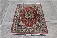 Lot 1541 - Persian-style rug with petalled central...