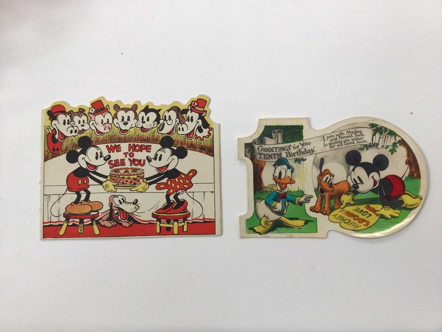 Lot 1424 - 1930s Greetings cards in two albums plus loose including 1938 Disney Snow White stand up diorama by Valentines, Mickey Mouse x2, children's novelty cards, earlier paper lace cards, Southampton fol...
