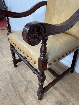 Lot 141 - Leather upholstered oak scroll armchair